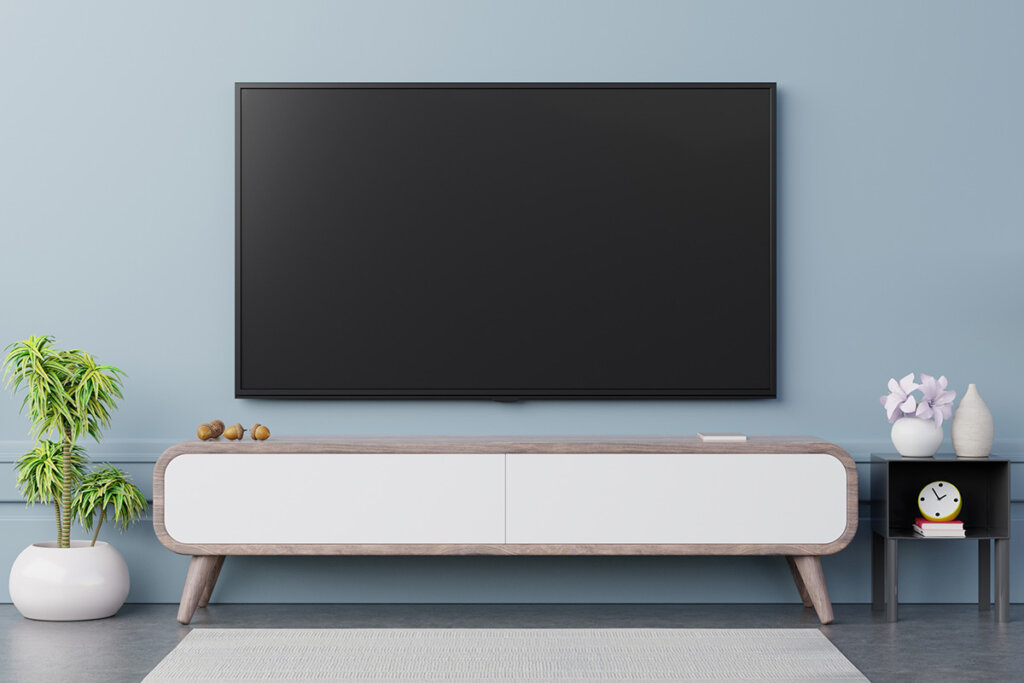 television_hanging_on_blue_wall_in_living_room